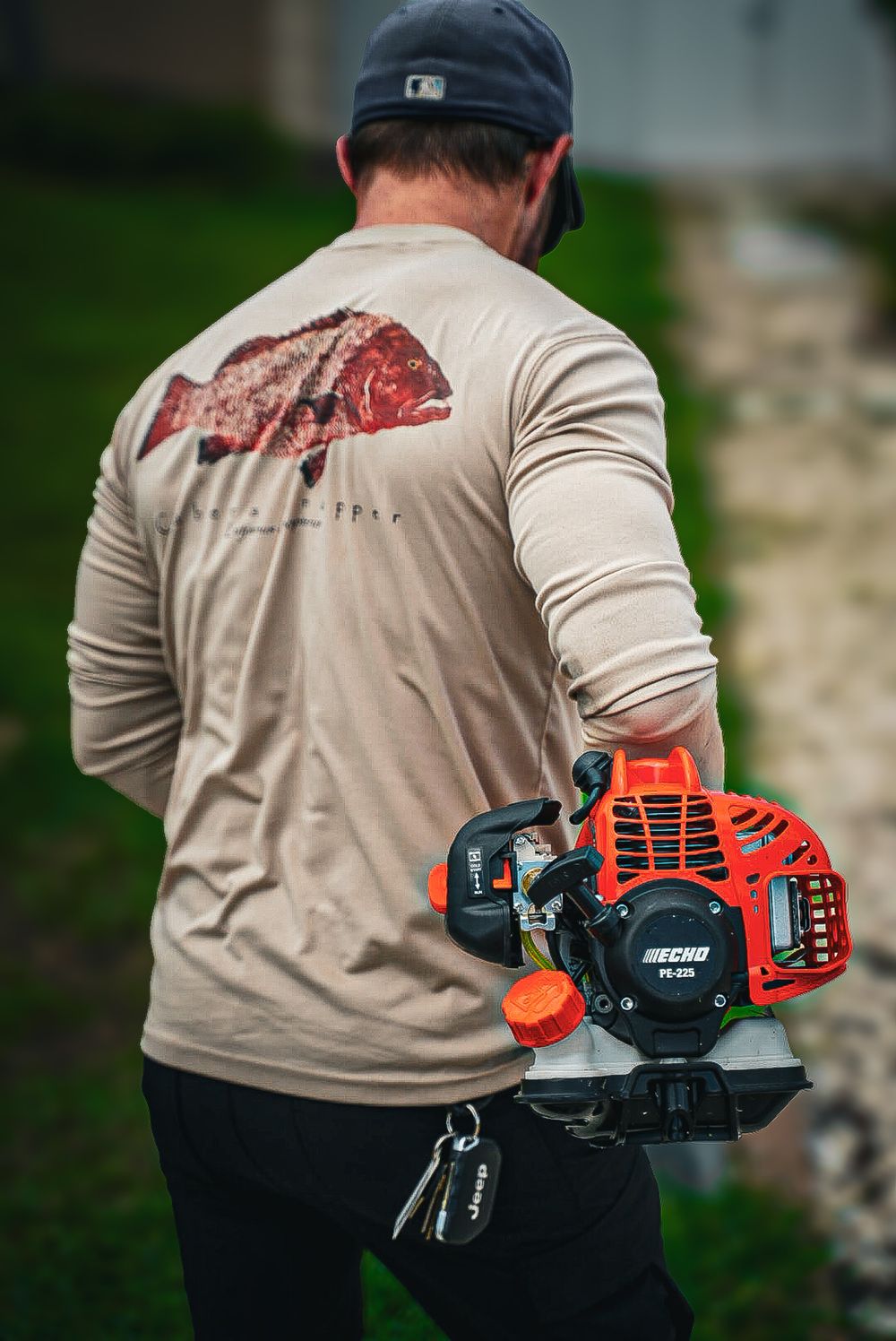 Lawn crew member walking the property with a string trimmer